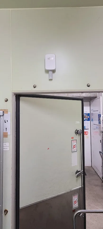 CropWatch wireless sensor mounted above a commercial walk-in cold room door monitoring temperature